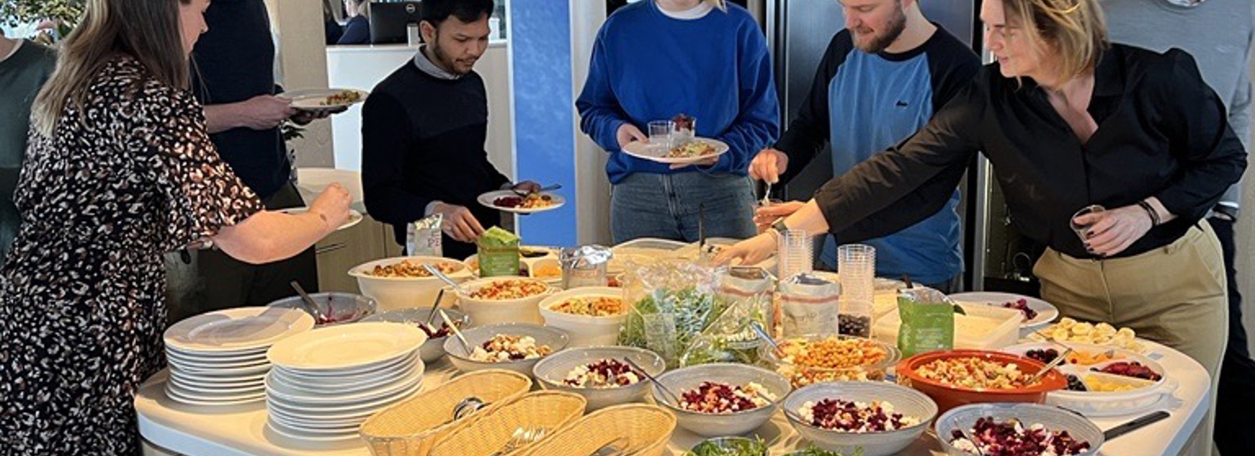 seven people grabbing a healthy lunch in a canteen